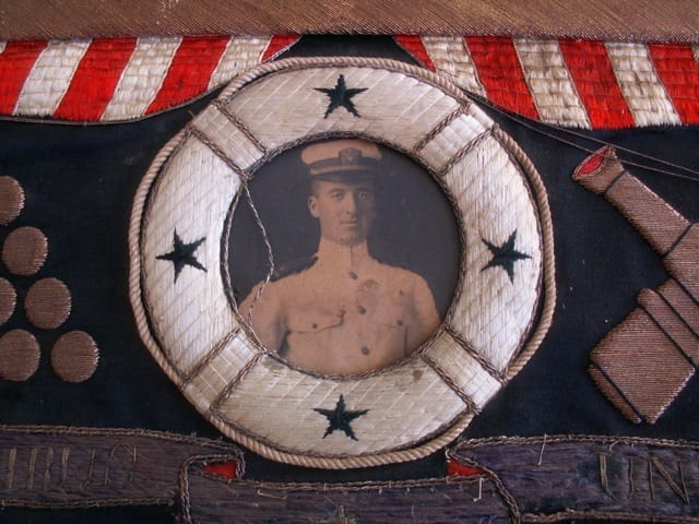 A sailor portrait medallion within a Great White Fleet commemorative textile banner.