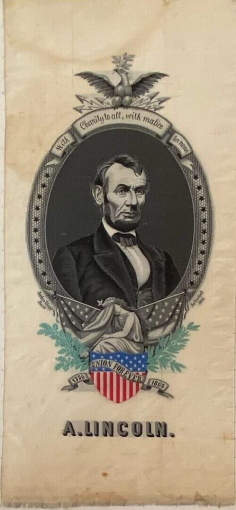 Vertical printed textile banner featuring Abraham Lincoln framed by patriotic imagery, shown cleaned and stabilized with improved surface clarity.