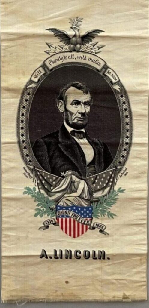 Vertical commemorative textile banner depicting Abraham Lincoln framed by an eagle and patriotic motifs, with the slogan “With Charity to all, with malice toward none” and “Union Forever, 1776–1865.”