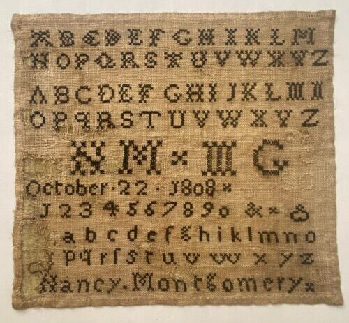 Rectangular linen sampler embroidered with rows of upper- and lowercase alphabets, numerals, decorative initials, and a stitched date reading “October 22, 1808,” laid flat after treatment.