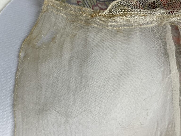 Close up of white silk chiffon fabric after the stitch repair is complete.
