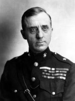 Black-and-white studio portrait of Smedley Butler wearing his U.S. Marine Corps dress uniform with service ribbons and insignia.