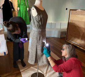Julia and her colleague examining a two-piece outfit from Princess Grace Kelly’s collection prior to exhibition.