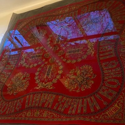 Dark red and black swirling patterns with blue reflections like water at top of photo.