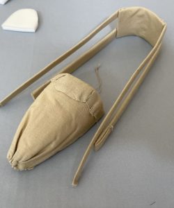 Deconstruction of Mother Seton's pointed cream satin slipper with embroidered monogram.