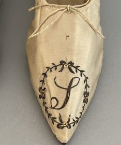 Mother Seton's pointed cream satin slipper with embroidered monogram.