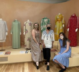 Julia and her colleagues pose in front of a gallery displaying Princess Grace Kelly's dress collection at Marjorie Merriweather Post’s Hillwood Estate.