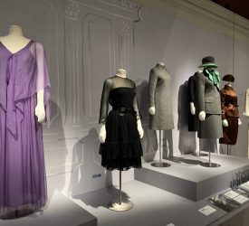 Mannequins displaying Princess Grace Kelly’s gowns and tailored suits in a museum gallery at Marjorie Merriweather Post’s Hillwood Estate.