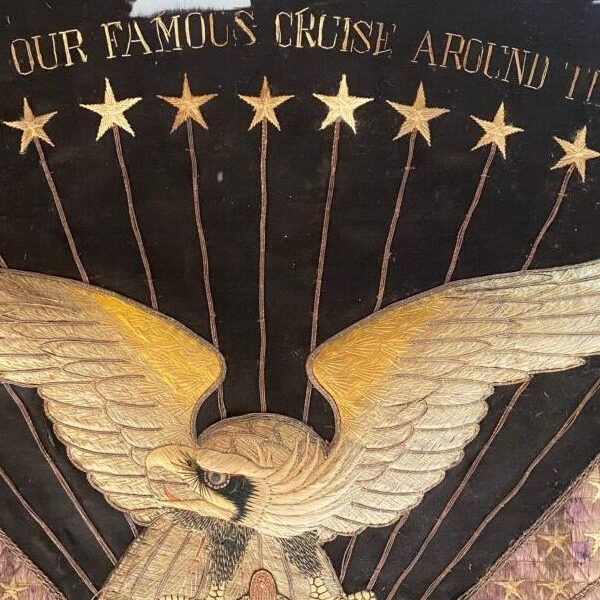 Repaired threads of stars and eagle flag stating "Our Famous Cruise Around the World"